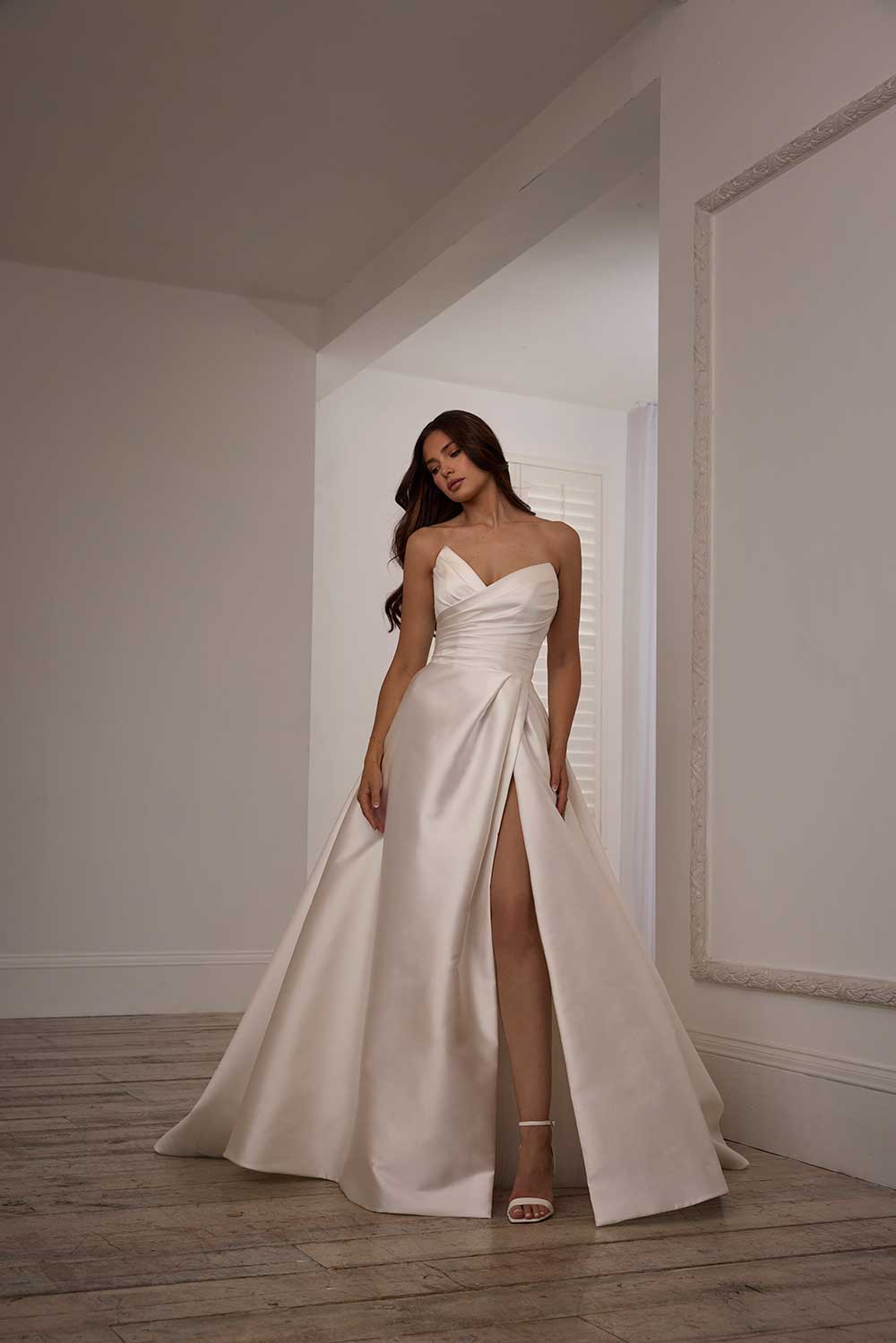 Suzanne Neville Dianthus satin strapless wrap wedding dress with slit skirt at Miss Bush bridal boutique in Surrey